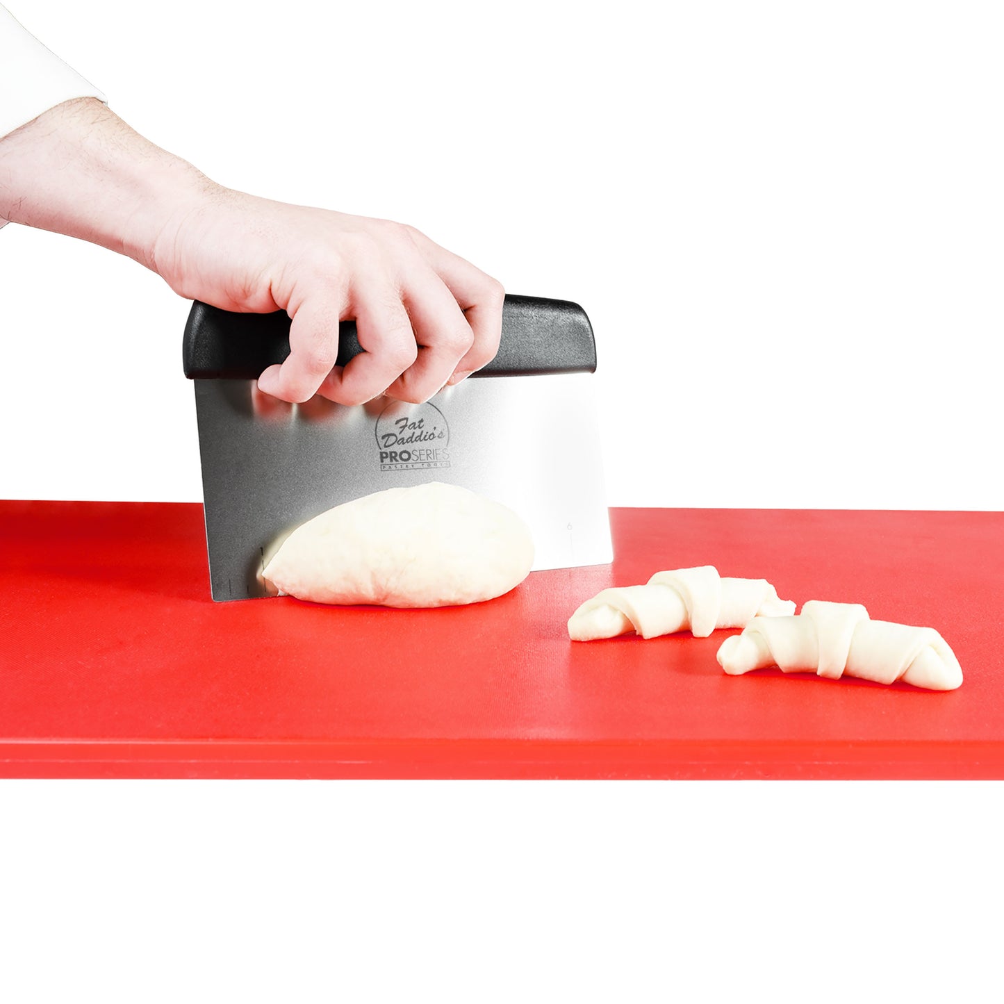 Bench scraper used by chef to cut dough on a red cutting board