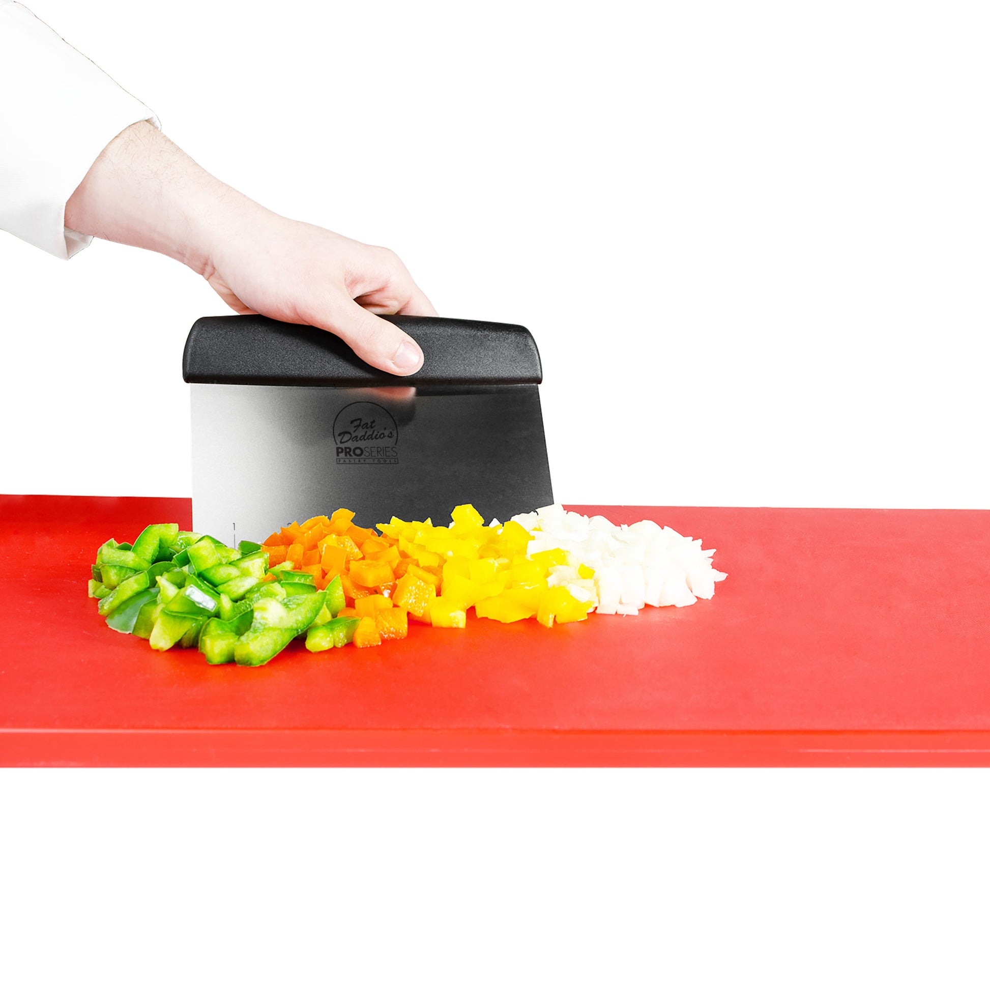 Bench scraper used by chef to chop vegetables, bell peppers and onions on a red cutting board