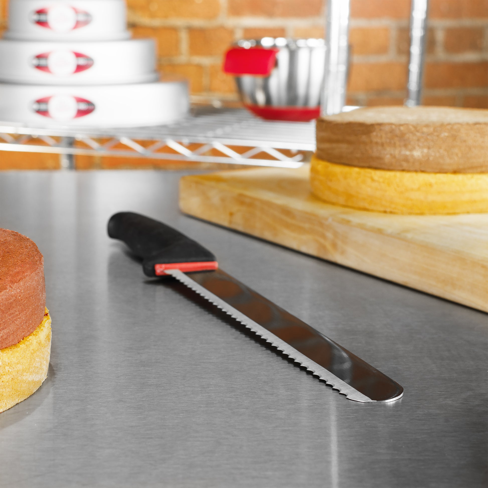 Bread & Cake Knife in a bakery with a wood cutting board and round cakes