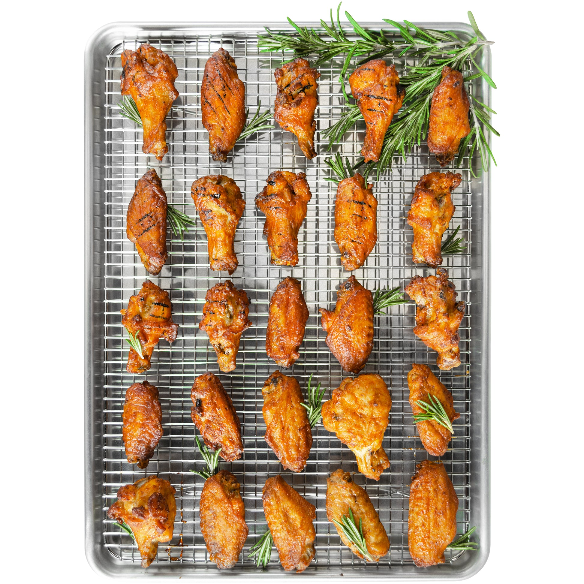 Roasted wings on a cooling rack nested in a baking sheet pan