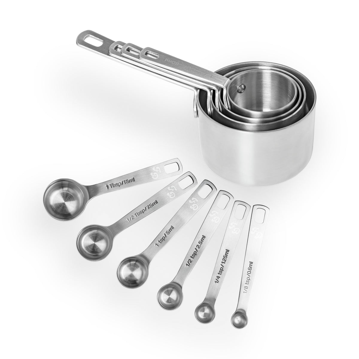 Stainless steel Fat Daddio’s measuring cups and spoons set arranged on a kitchen surface