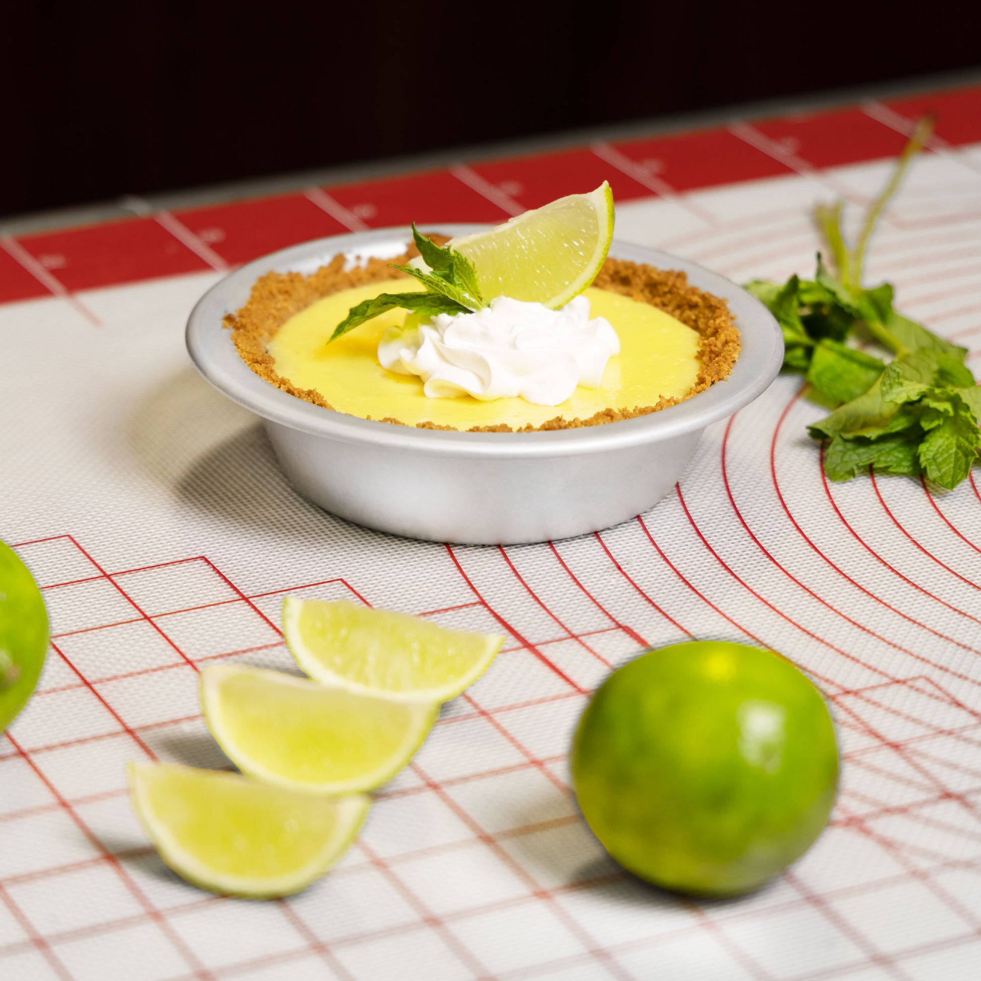 Mojito pie with limes on a silicone work mat in a commercial kitchen