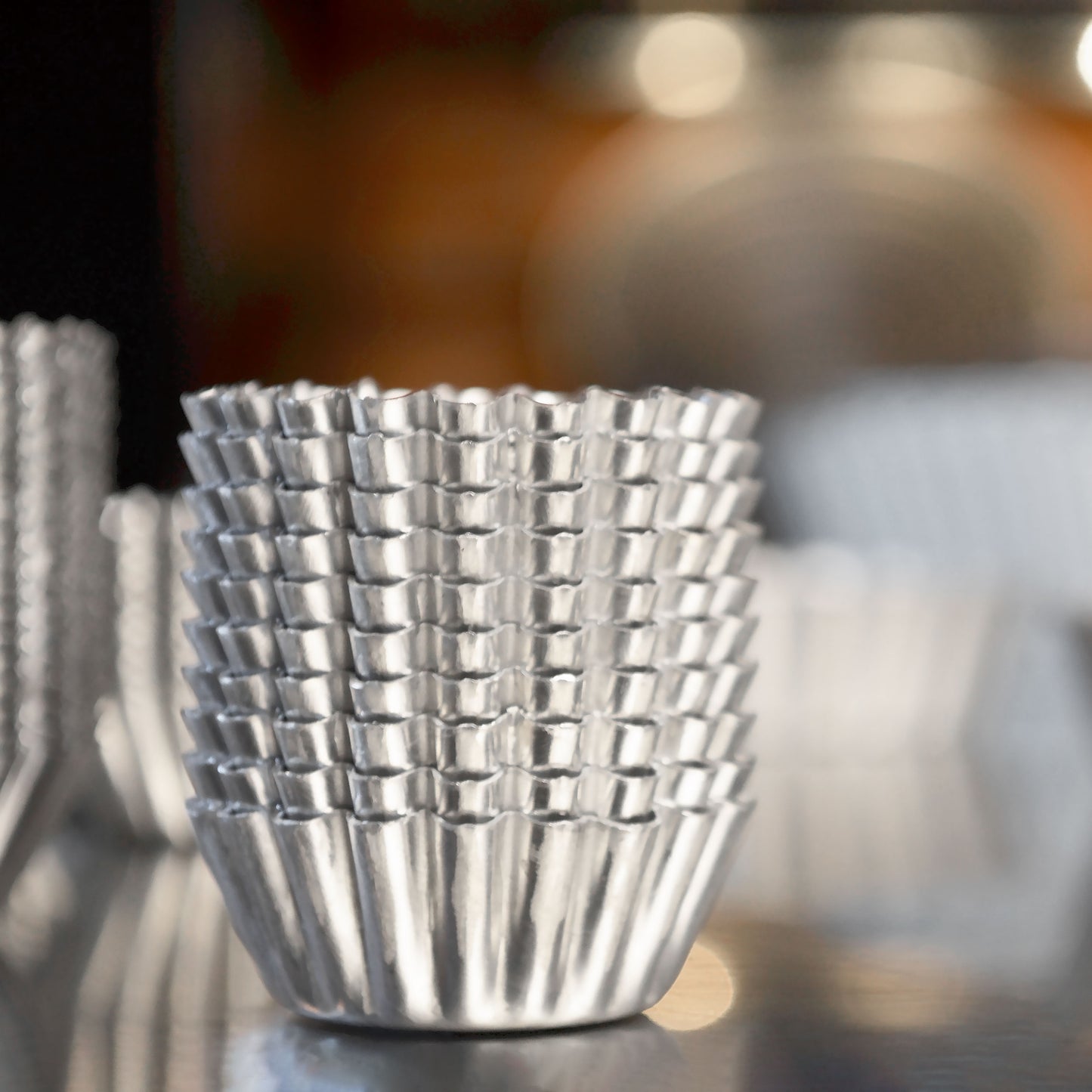 Stacks of mini tartlette pans in a commercial kitchen